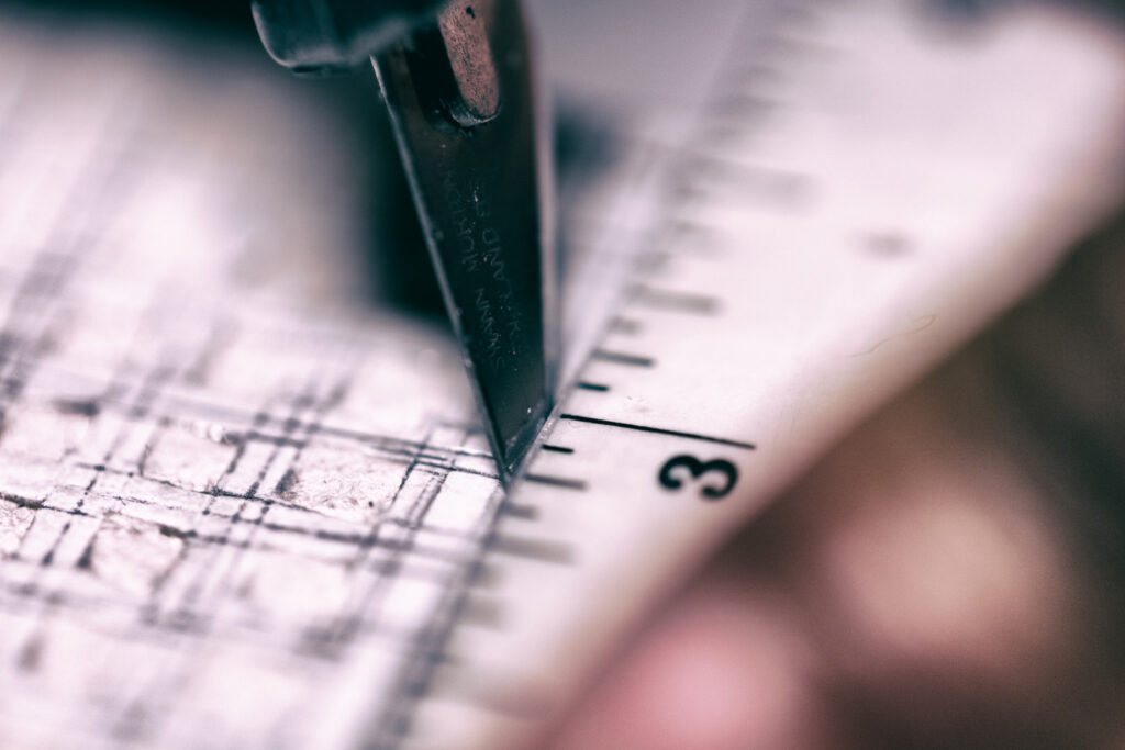 close up photo of stanley knife cutting through paper