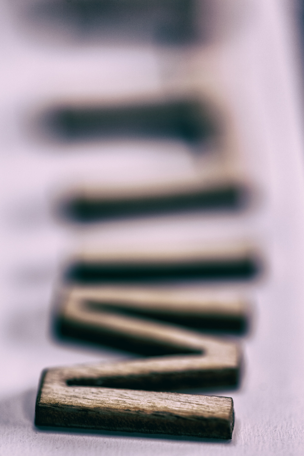 close up photo of wooden letters on desk, soft focus