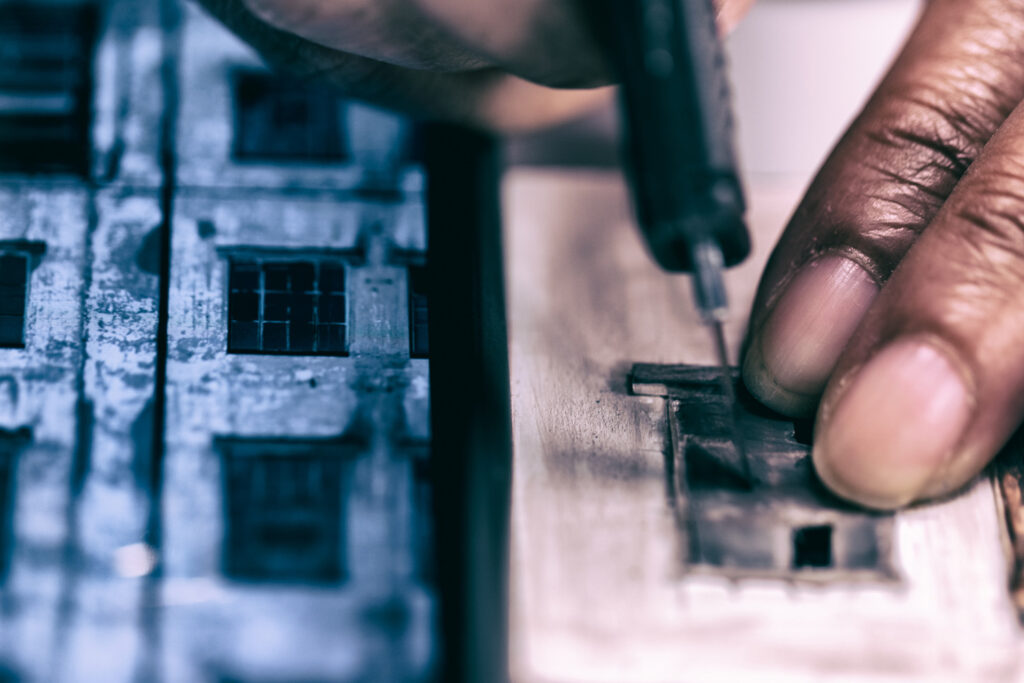 close up photo of hands making a miniature facade